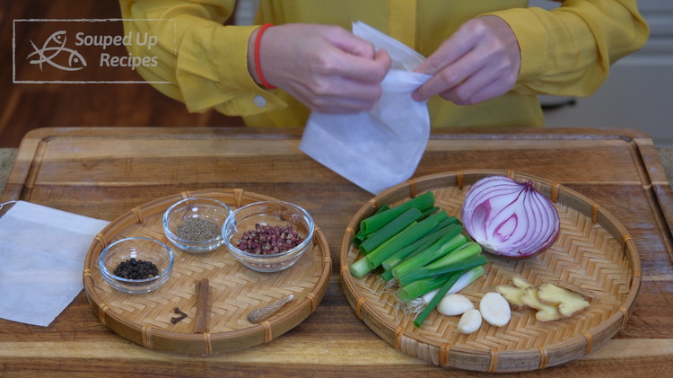 Image of Meanwhile, put the following aromatics and spices into disposable spicy bags: ginger, garlic, scallions, purple onion, cinnamon stick, cloves, black peppercorns, fennel seed, Sichuan peppercorns, and dried Angelica root (optional).