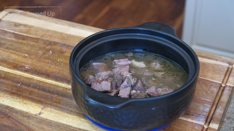 Image of Discard the bones and the spice bag. Put the beef meat back into the clay pot. Set it aside.