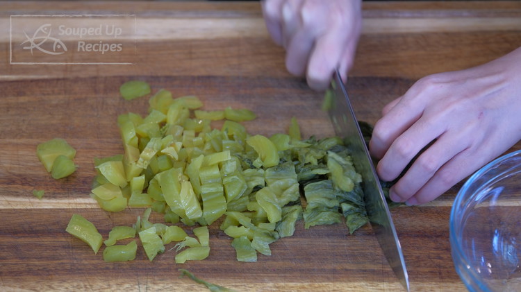 Image of Rinse the pickled mustard green with running water to remove the excess salt and roughly dice it. For those who don't have access to buy pickled mustard green, you can use Sauerkraut as a replacement. You just need to add...