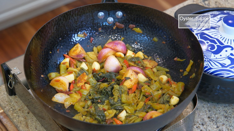 Image of Add the pickled mustard green, switch the heat to high, and keep stirring for a few minutes to activate the umami flavor.
