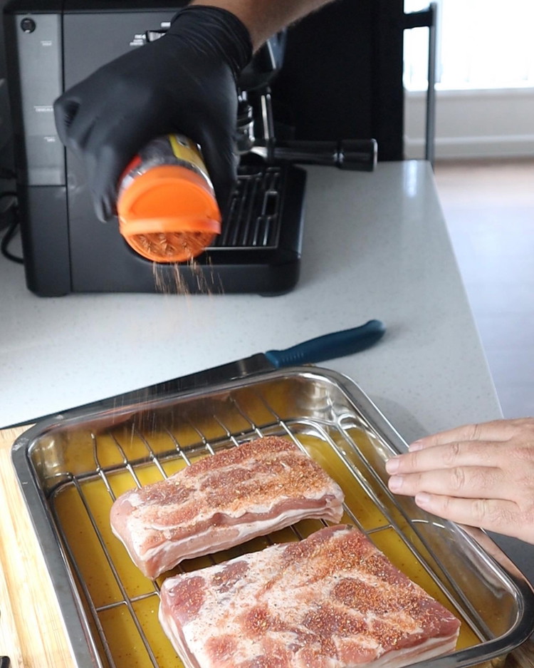 Image of After the air drying stage in the fridge, you want to season the meat side of the pork. Seasoning the skin will cause it to burn when subjected to high heat. Lightly season the skin with salt only.