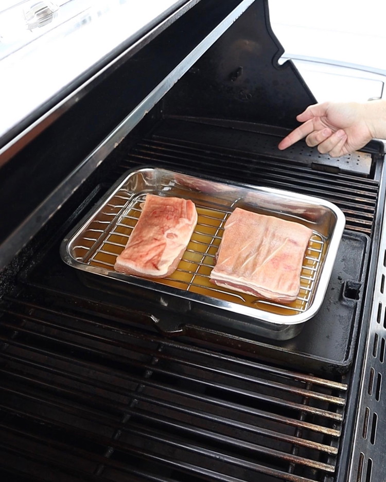 Image of Bang pork into a pre-heated oven, or BBQ at 150-160C. Ensure you place the tray with pork indirect to the heat source. Optional step here is to add some stock and a dash of apple juice in the tray, ensuring...