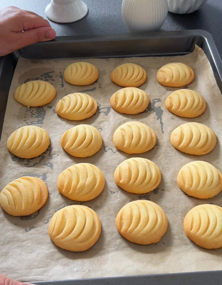 Image of Place the shaped cookies on a baking sheet lined with parchment paper and bake in a preheated oven at 160°C (320°F) for about 10-15 minutes, keeping an eye on them. The cookies should be lightly browned on the bottom but...