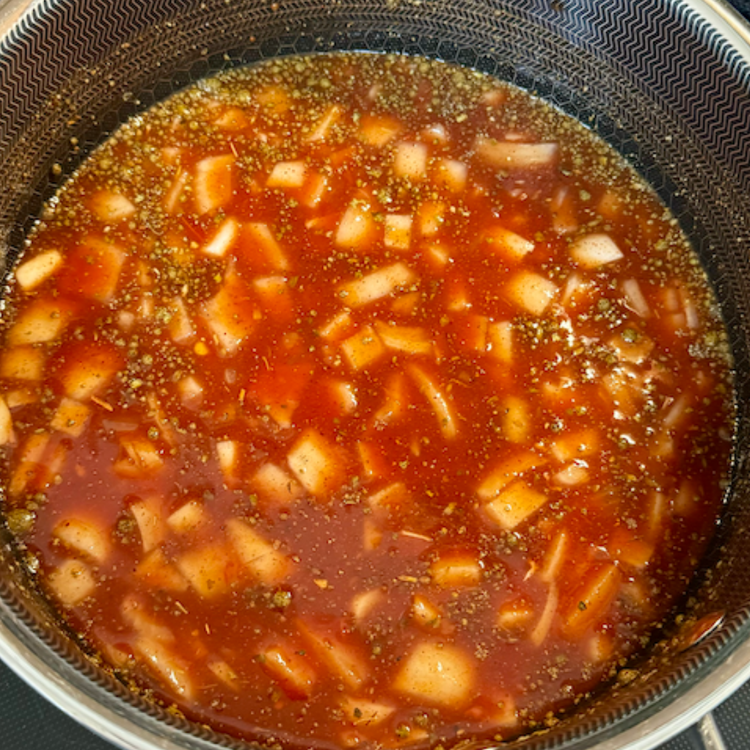 Image of You should make your red sauce simultaneously with the green sauce and with cooking the ground elk. It takes longer to cook down, so it's important to get it going at the same time as the green sauce. Grab another...