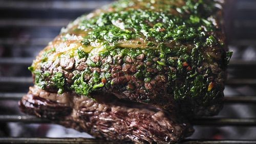 Image of Whole grilled flank steak with wild garlic chimichurri