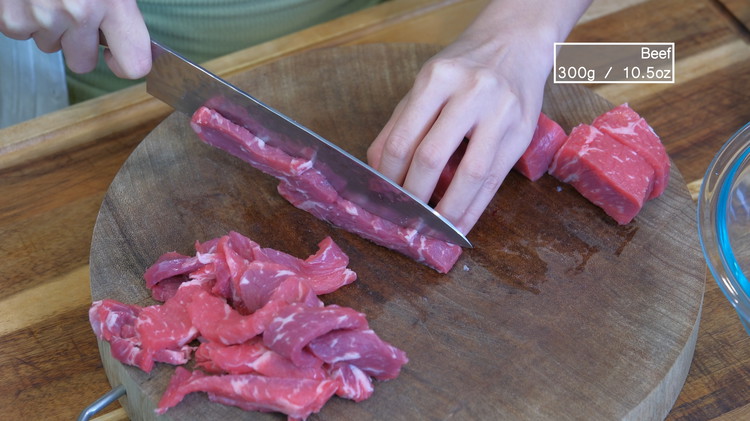 Image of Slice the beef into 1/4 of an inch thick pieces. I am using New York strip steak, but other tender cuts such as ribeye, sirloin, and flank steak will also work. 