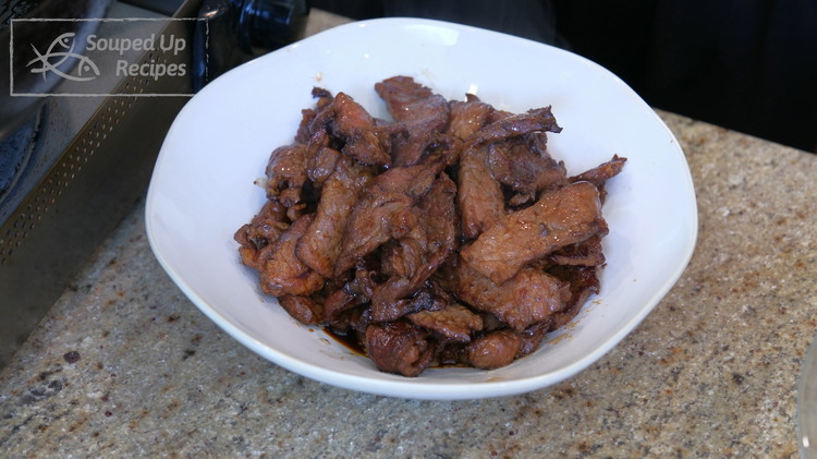 Image of Remove the beef from the wok. Make sure you tilt the wok so you can leave the oil behind. Set the beef aside.