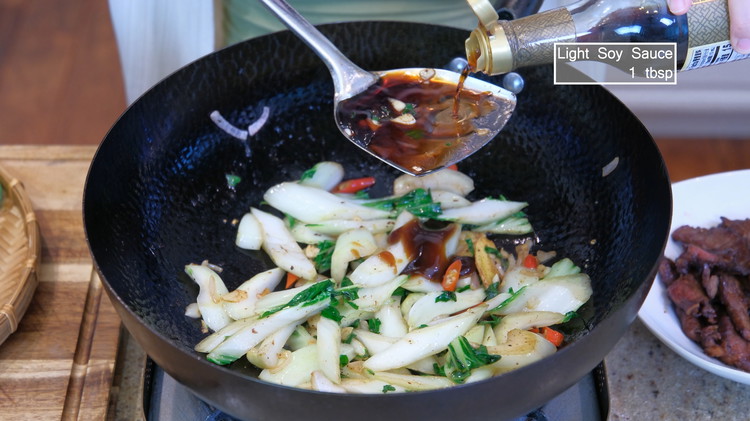 Image of Season it with oyster sauce and soy sauce. Make sure you drizzle it from the side of the wok so the heat can caramelize the sauce and create complex flavors.