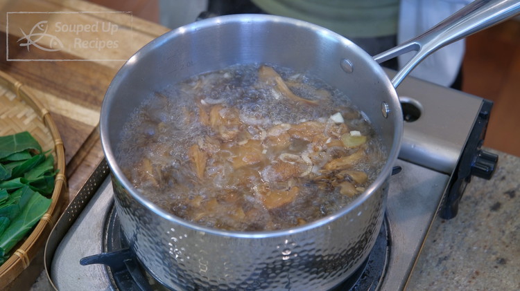 Image of Add the mushroom along with it’s soaking liquid. Turn the heat to medium and bring it to a boil.
