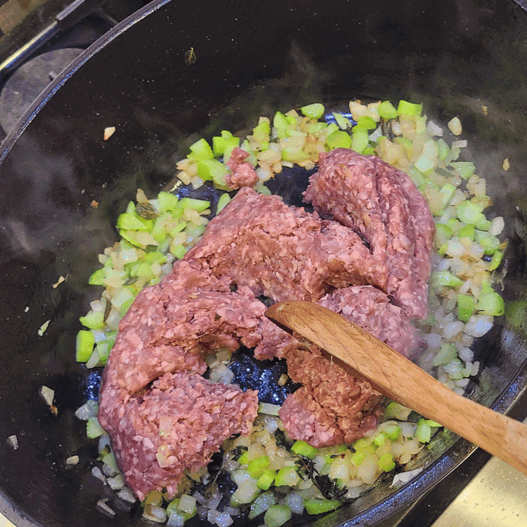 Image of Remove the herbs and set aside. Add in the meat and break it up into small pieces as it browns.