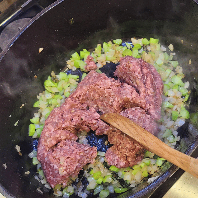 Image of Remove the herbs and set aside. Add in the meat...