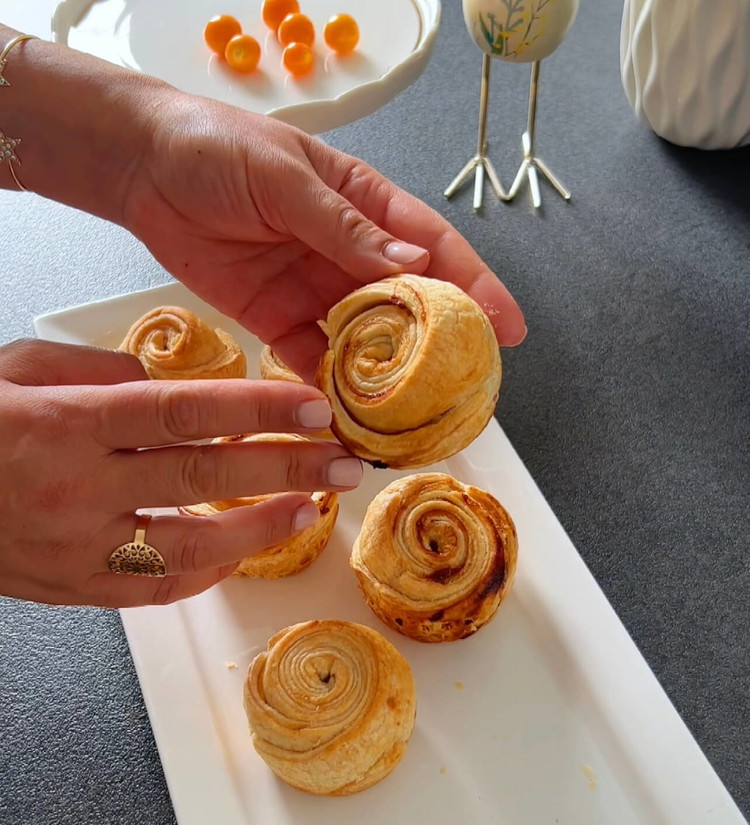 Image of Coloque a forma de muffin no forno pré-aquecido e asse os Cruffins por aproximadamente 50 minutos ou até que estejam dourados. Certifique-se de que tenham crescido e estejam crocantes.