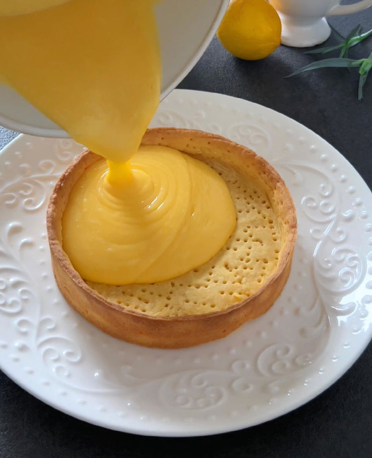 Image of Смесете лимоновия сок, настърганата кора, захарта и яйцата в тенджера....