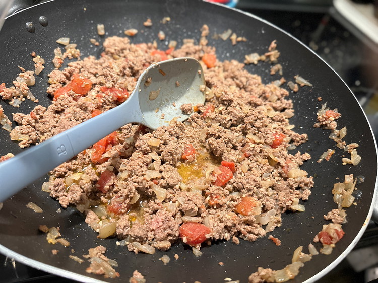 Image of Add 1 tab of butter or dab of oil to a large frying pan. Add your onions and cook on medium-high heat until they begin to soften. Add your hamburger and spices. Once your meat is almost browned through add...