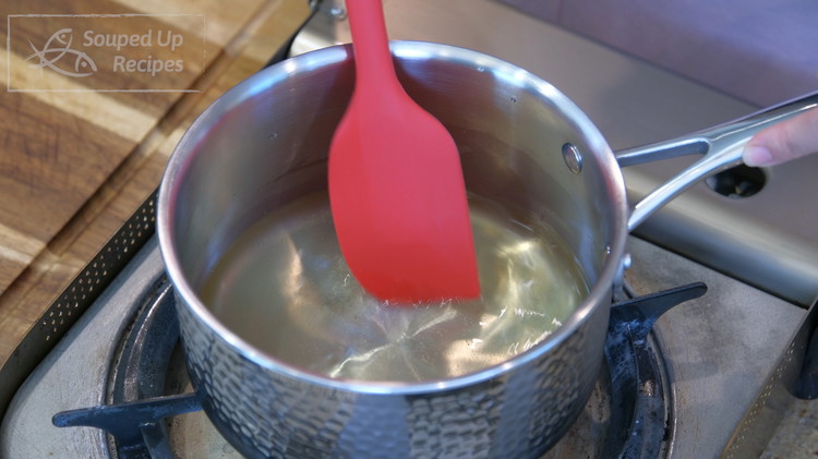 Image of In a saucepan, add 1/2 tbsp of sugar, 1/2 tbsp of honey, 1/4 cup of white vinegar, and 1/4 cup of water. Stir everything over medium heat until dissolved, and set the glaze aside. Traditionally, we use maltose, but honey...