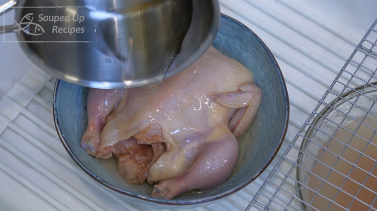 Image of Put the cornish hen into a big clean bowl, pour the glaze onto the chicken, and rub it all over the skin. The sweetener in the glaze will caramelize while roasting, and that is how the skin gets beautiful. This...