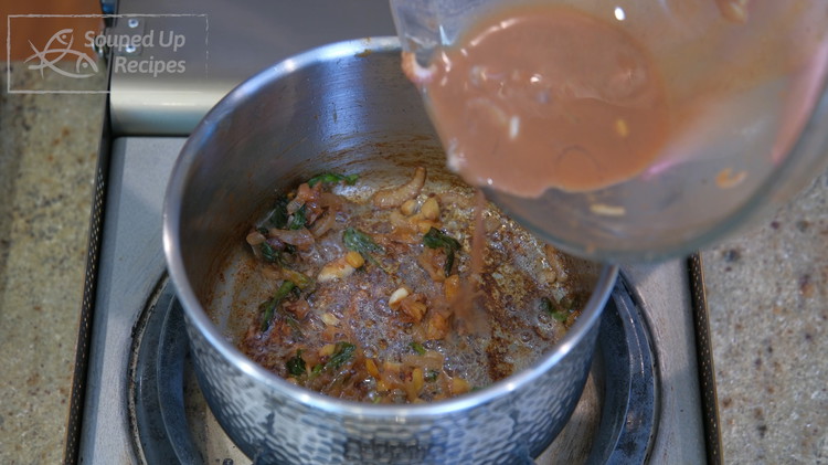 Image of Add the remaining sauce and stir well. Pour in 1/4 cup of water and simmer it for a minute or 2. Let the sauce go through a sieve. You can drizzle this onto the rice and the chicken.