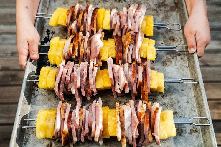 Image of Using double skewers, tightly stack two pieces of pineapple, then...