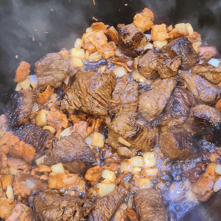Image of Add the chopped onion, garlic and bacon and cook over moderate heat, stirring occasionally, until the onion is softened, and fat is starting to render from the bacon.