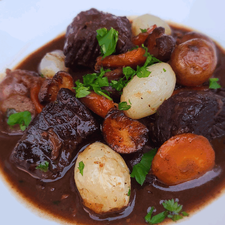Image of To serve, stir some of the vegetables into the stew and scatter the rest on top as a garnish. Top with a little chopped parsley and serve.