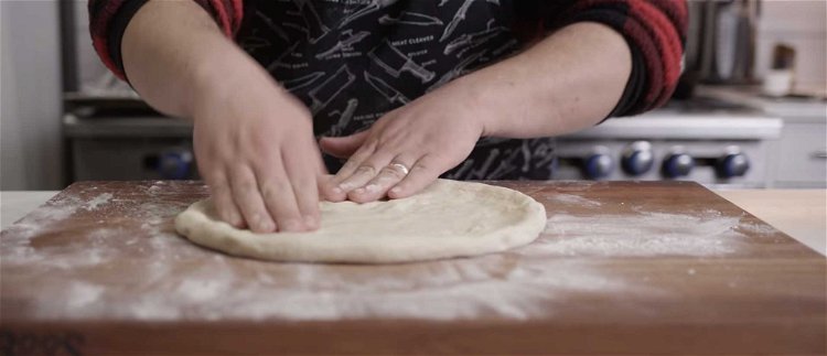 Image of On a floured work surface, stretch the dough thin.