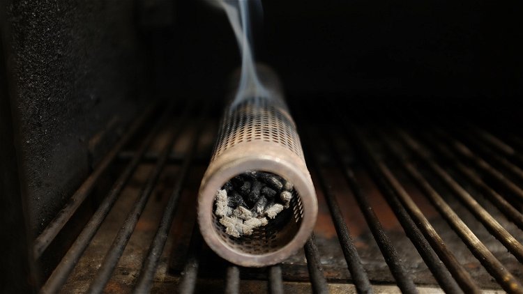 Image of Fill an A-MAZE-N Tube Smoker with hickory pellets. Place the...