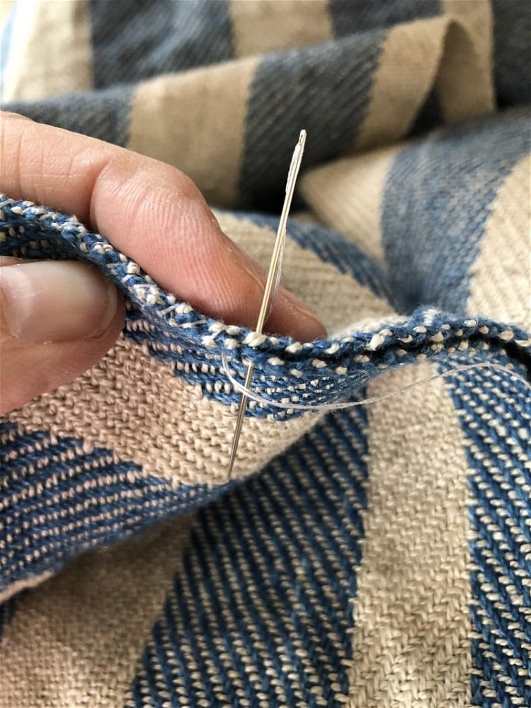 Image of Using a doubled thread and a needle, sew the two...