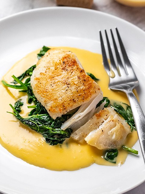 Image of Serve halibut cheeks hot over beurre blanc sauce.
