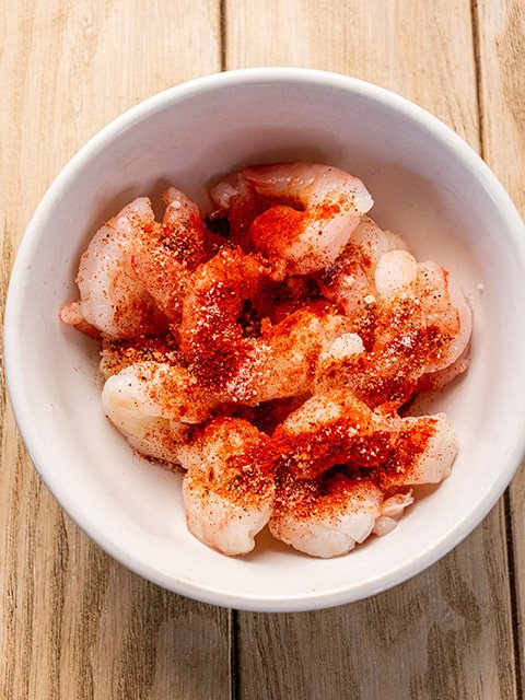 Image of Toss shrimp in smoked paprika, salt and pepper in a...