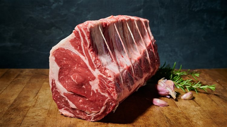 Image of Place the beef in a roasting pan bone-side down and...