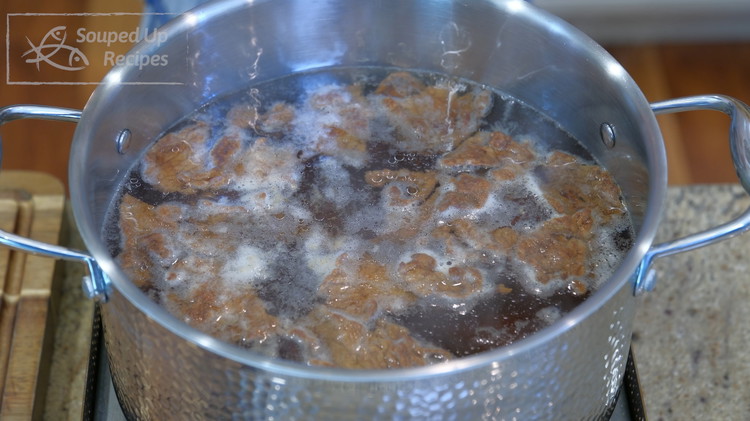 Image of Continue to use this pot of water to poach the beef. Turn the heat to the lowest and make sure the water bubbling activity is subtle. Add the beef slices one by one and wait for a couple of minutes...