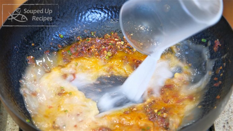 Image of Pour the starch water into the wok. Bring it to...