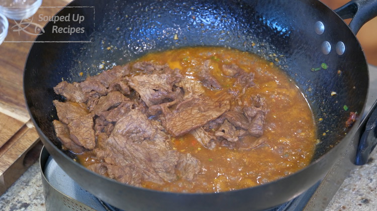 Image of Introduce the beef into the wok and let it simmer for one 1 minute. Taste to adjust the flavor. It should be a lot saltier compared to your normal taste because the tofu doesn’t have that much flavor.