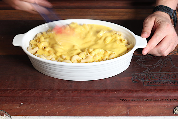 Image of once pasta is just undercooked (slight chew when you bite it), drain the water and add pasta and cheese sauce to a ceramic heat proof dish