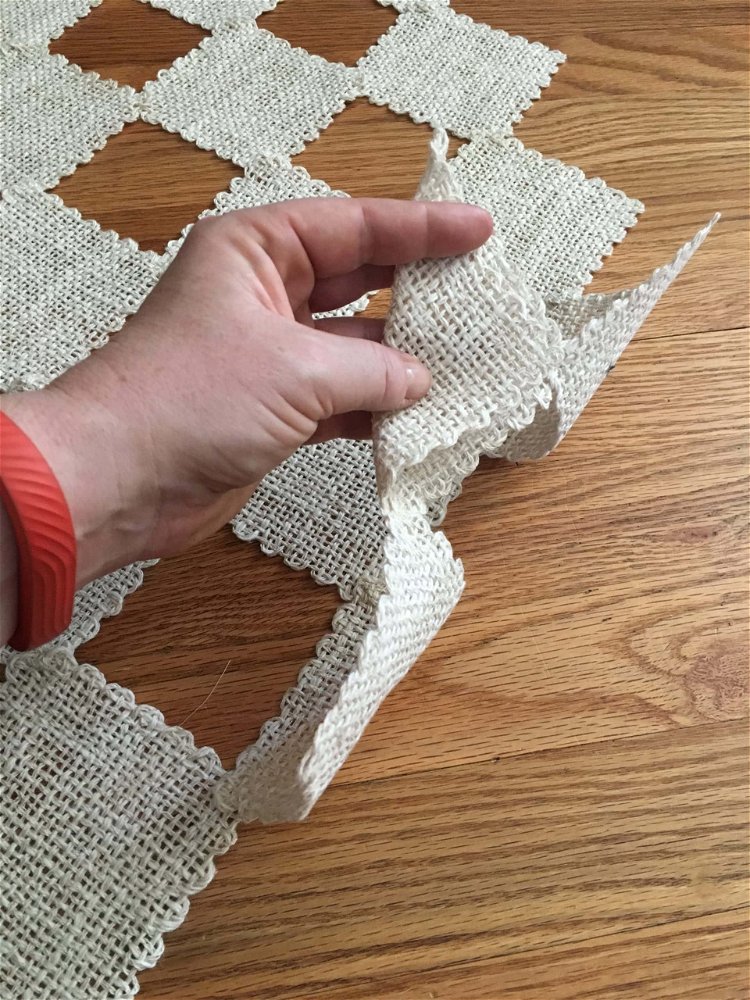 Image of Now, fold over the edge squares as pictured, and stitch.