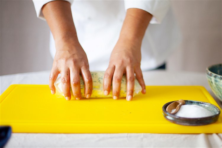 Image of Roll the herbed butter mixture into a cylinder using kitchen...