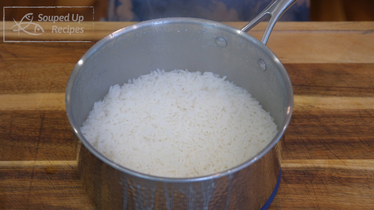 Image of Put on the lid. Switch the heat to low and cook the rice for another 15 minutes.