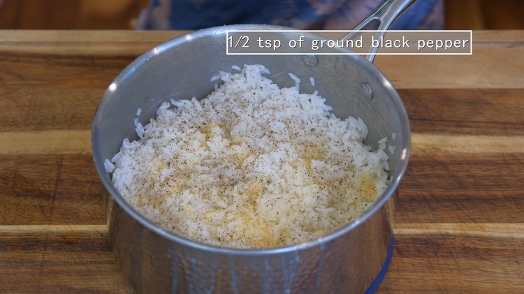 Image of Once done, fluff the rice and season it with 1/2 tsp of salt, 1/2 tsp of garlic powder, and some ground black pepper to taste and mix well.