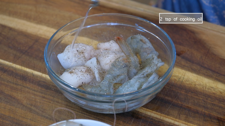 Image of Season the seafood with salt, some black pepper to taste, and a drizzle of cooking oil. Mix well and set it aside.