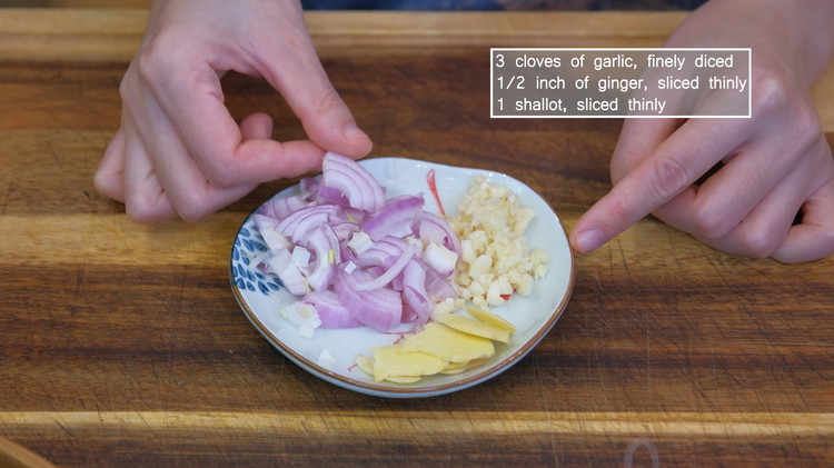 Image of Besides that, finely dice three garlic cloves, slice 1/2 inch of ginger, and one shallot.