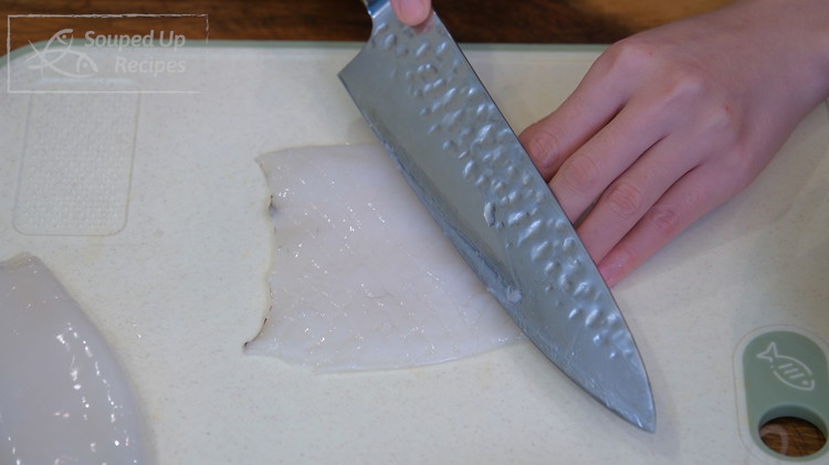 Image of Cut the squid tubes open and score them with crisscross pattern. Make sure the cuts are on the inside of the squid because squid curls from the inside out. Set it aside.