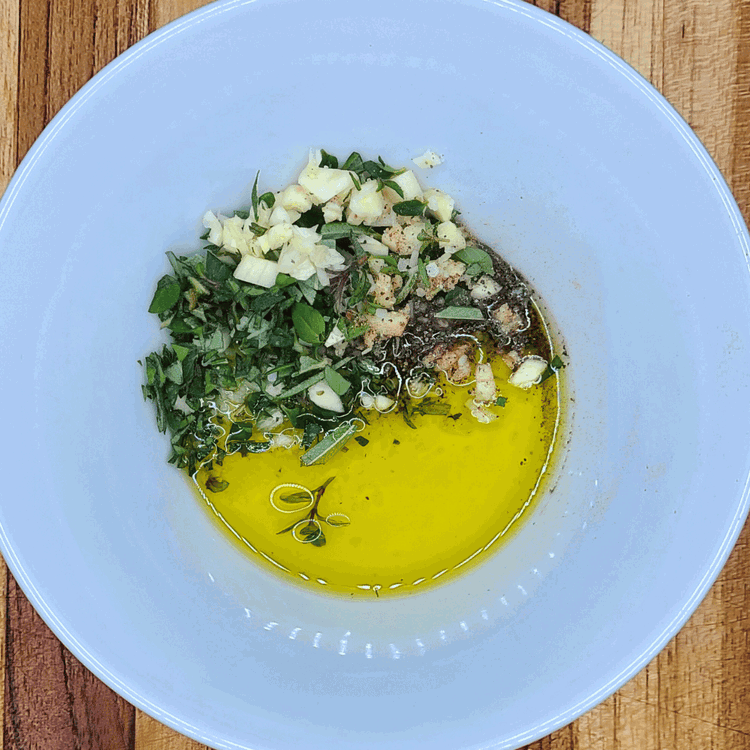 Image of Combine the olive oil, garlic and herbs in a small bowl and stir to combine.