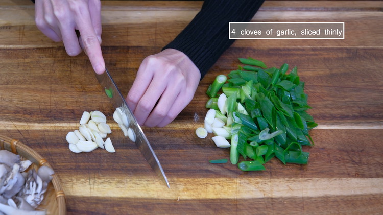 Image of Dice 3 scallions diagonally into 1/2 inch pieces; slice 4 cloves of garlic thinly.