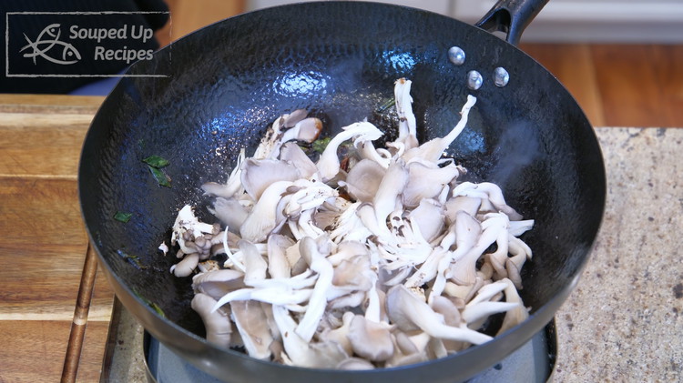Image of Add the oyster mushrooms and stir over medium-low heat for a few minutes or until they are wilted.