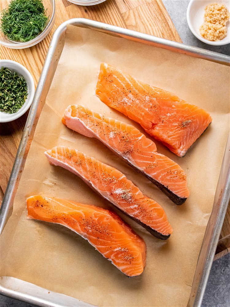 Image of Place salmon portions on baking sheet and season with salt...