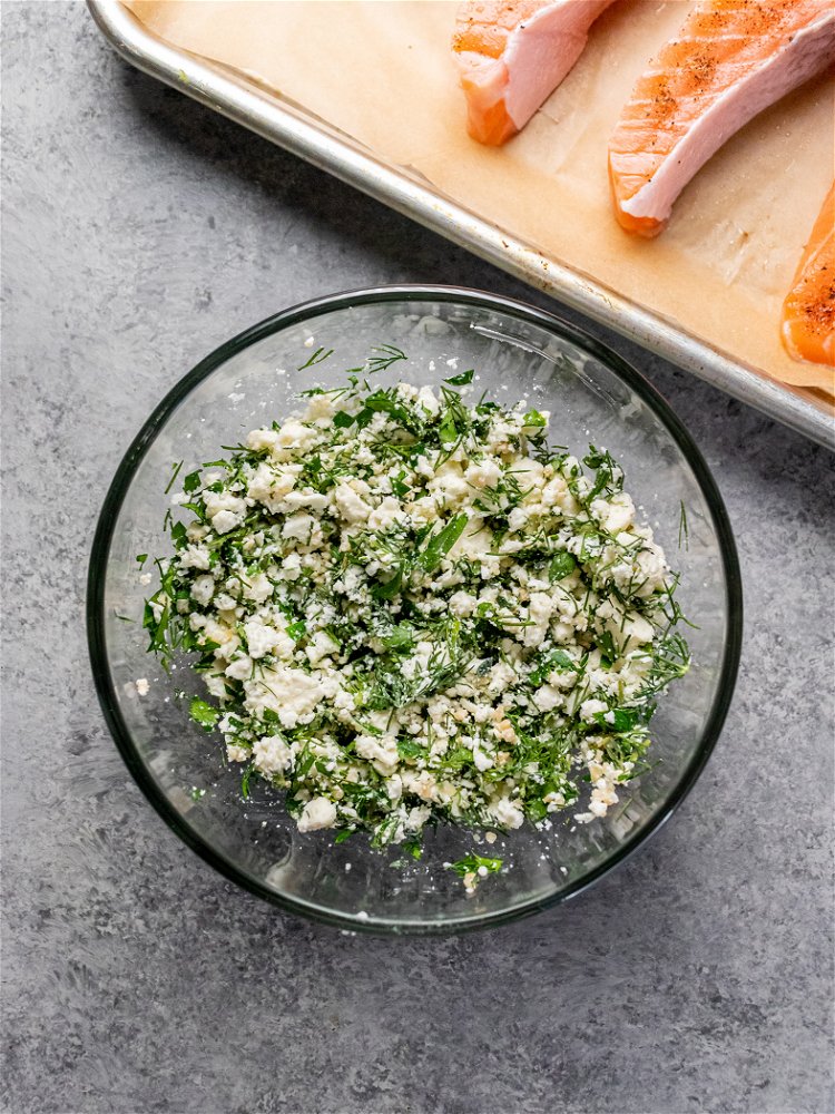 Image of In a small bowl, combine feta, parsley, dill, thyme, and...