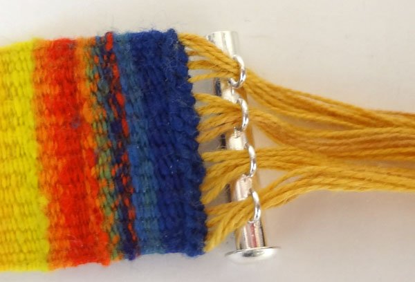 Image of To add the clasp, divide the warp ends and insert...