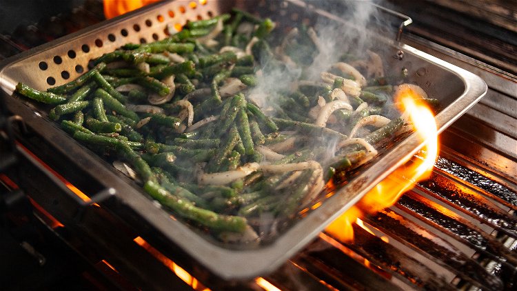 Image of Dump the green bean mixture into the grilling basket. Let...