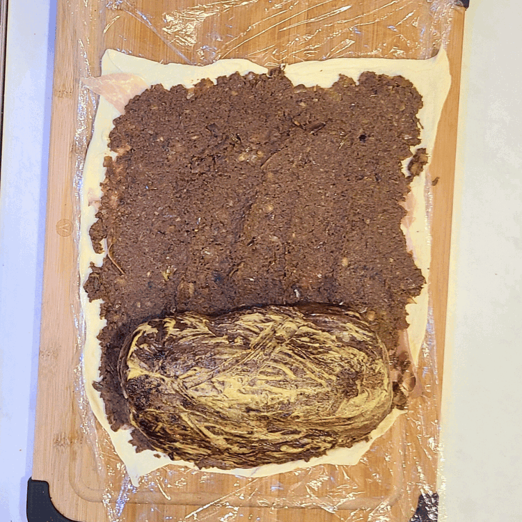 Image of Season the tenderloin with some salt and pepper, then place it at the bottom of the prosciutto. Roll into a “log”, using plastic wrap to roll tightly. Tuck the ends of the prosciutto and pastry as you roll, then twist...