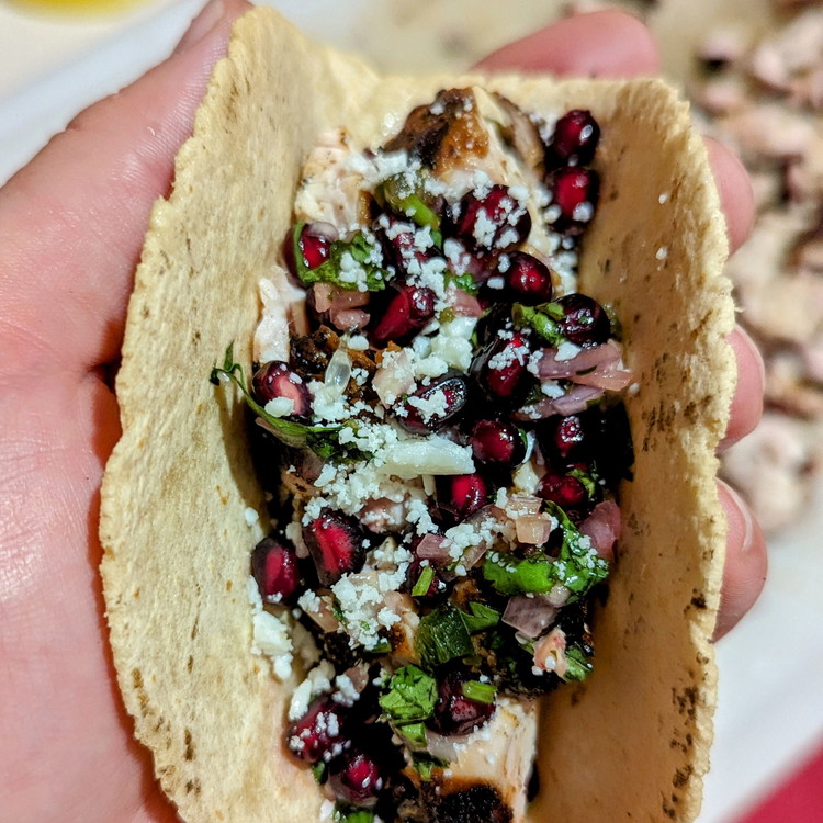 Image of Top with pomegranate salsa, Cotija cheese, and a squeeze of lime juice.